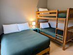 Full size bed and twin over twin bunk bed in the guest bedroom